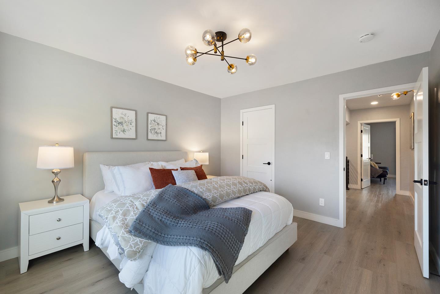 488 Monterey Road Pacifica, CA 94044 - Photo 43 of 78 a spacious bedroom with a bed and a chandelier