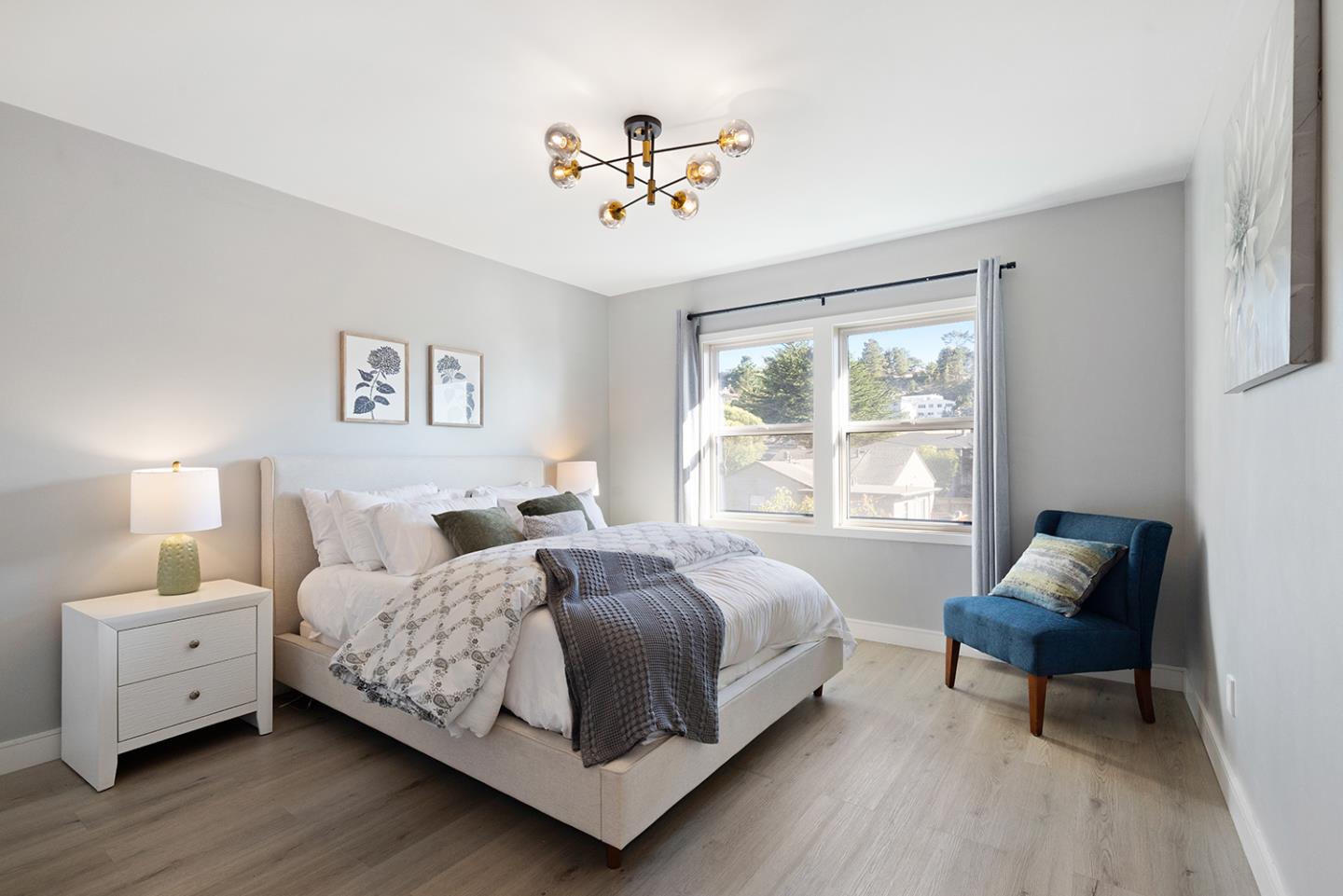 488 Monterey Road Pacifica, CA 94044 - Photo 44 of 78 a bedroom with a bed and a chandelier