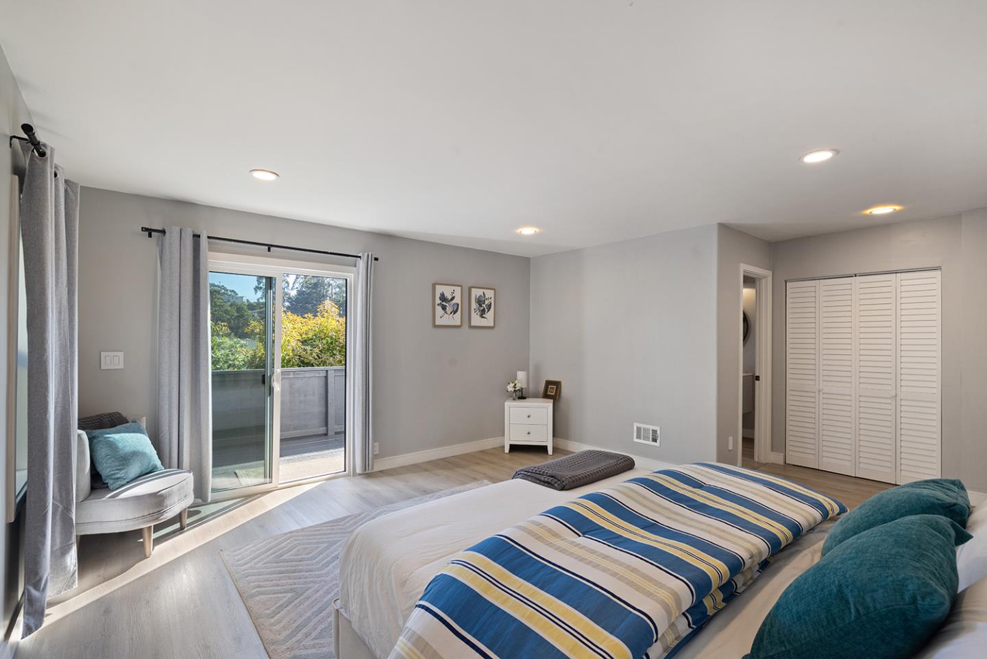 488 Monterey Road Pacifica, CA 94044 - Photo 61 of 78 a bedroom with a bed and glass door