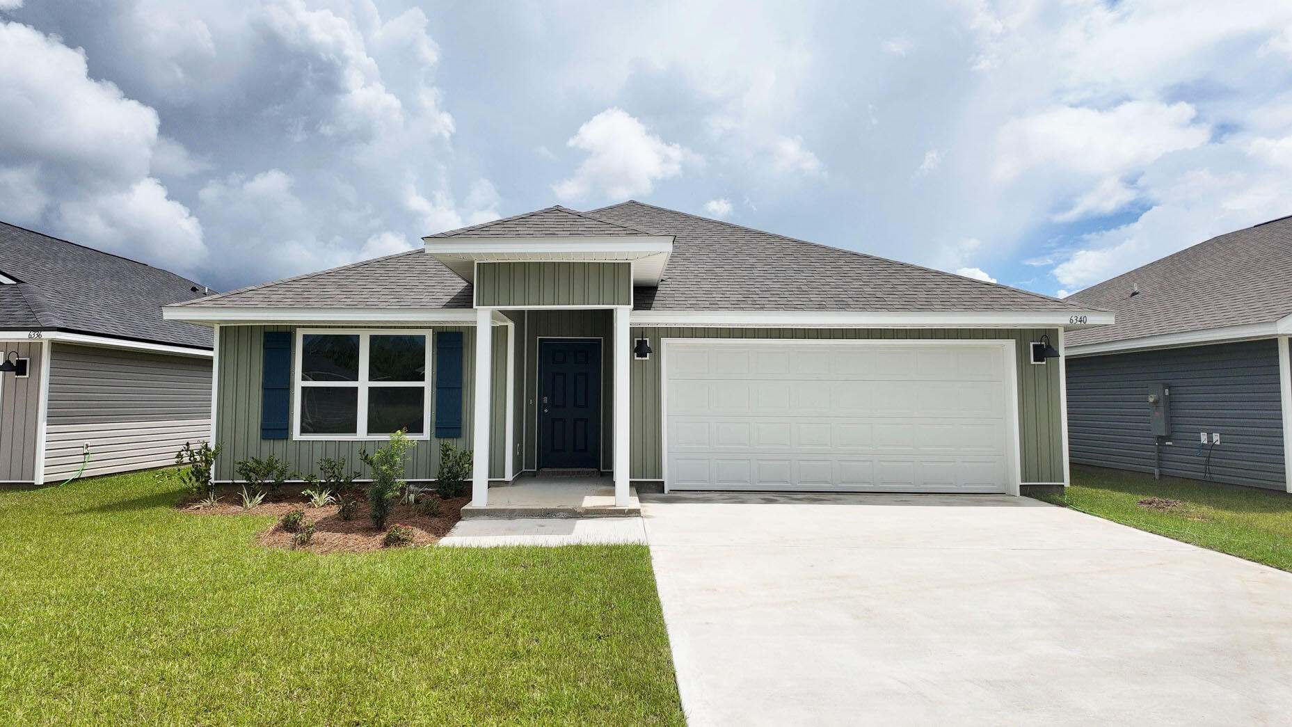 a front view of a house with a yard and porch