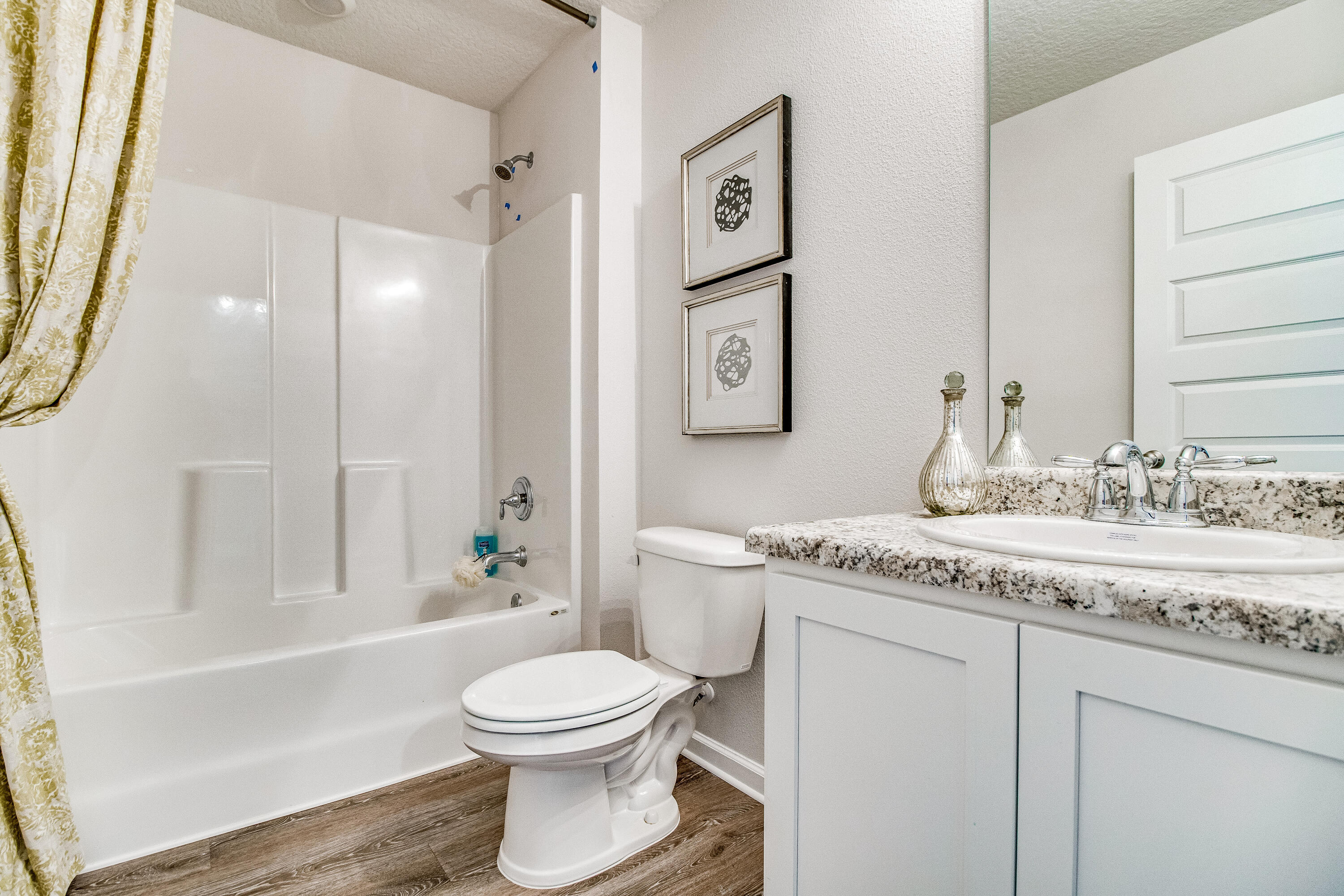 6340 Firefly Drive Milton, FL 32583 - Photo 19 of 30 a bathroom with a granite countertop sink a toilet and shower