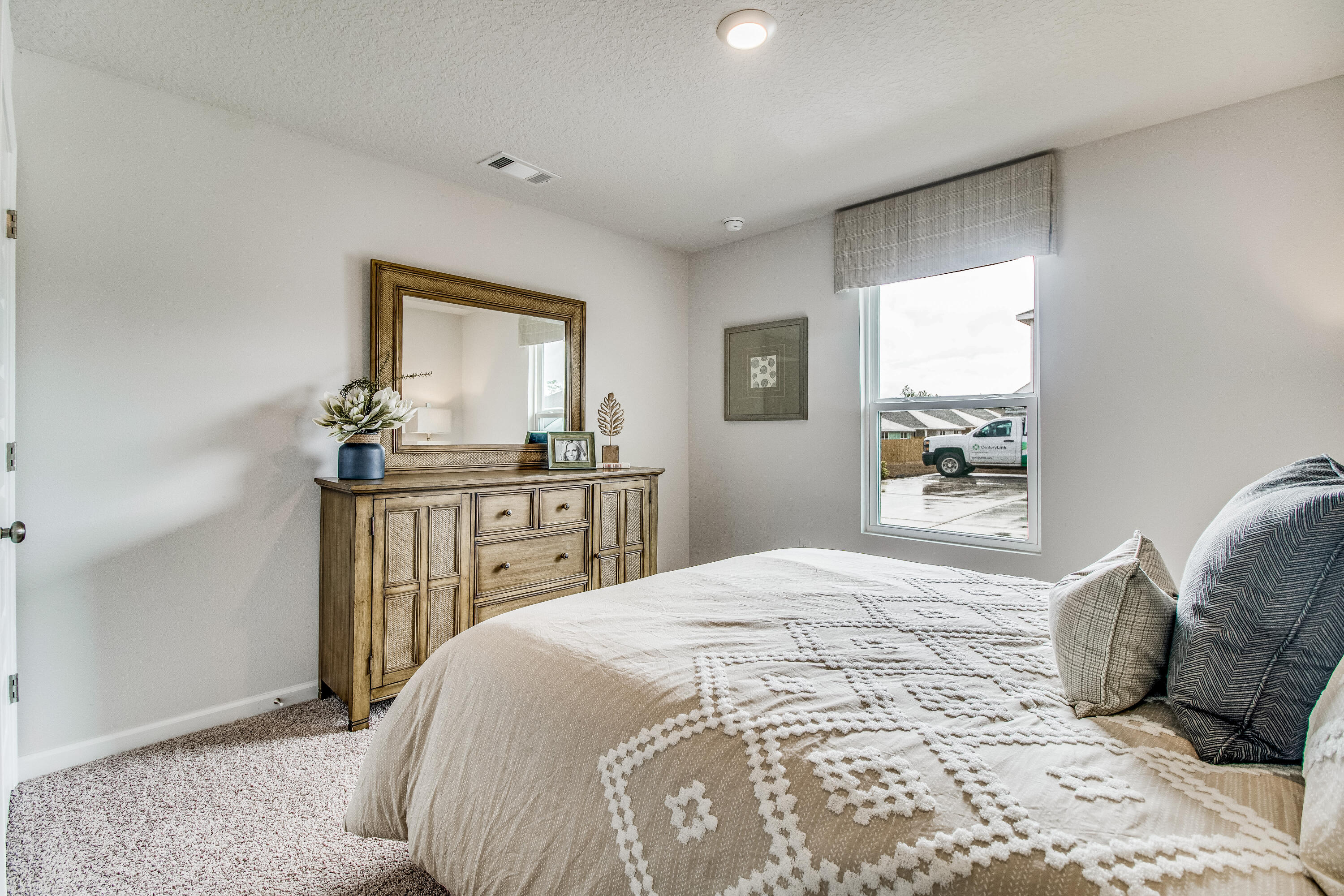 6340 Firefly Drive Milton, FL 32583 - Photo 20 of 30 a bedroom with a bed next to a window with a dresser