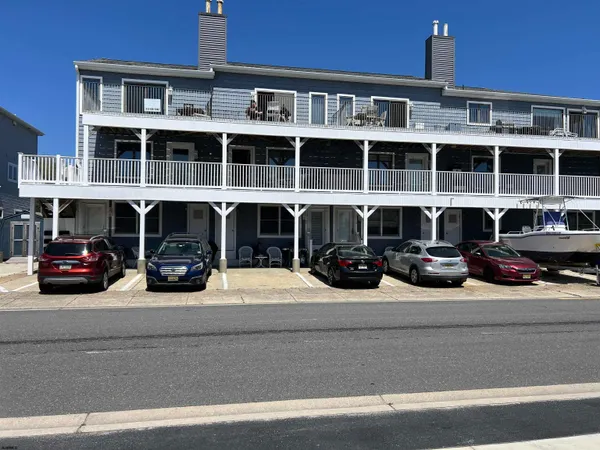 a view of a street that has a couple of cars parked in front of it