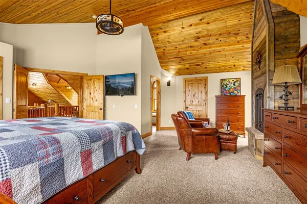 a bedroom with a bed and large windows