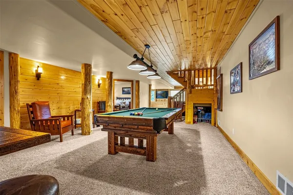 a room with furniture pool table and windows