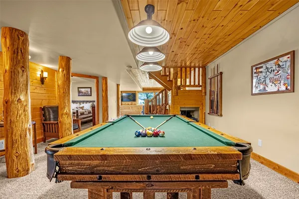 a room with pool table and windows