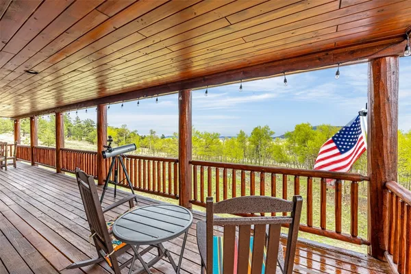 a view of a two chairs in the balcony