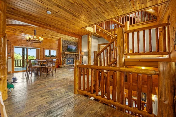 a view of a chairs and table on the wooden deck