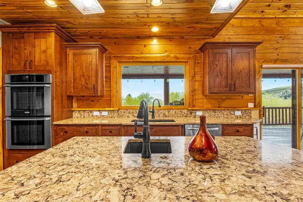 a view of a kitchen with a sink and cabinets