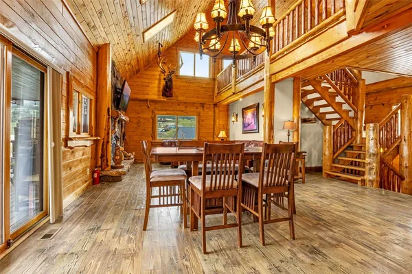 a view of a patio with a table and chairs and wooden floor