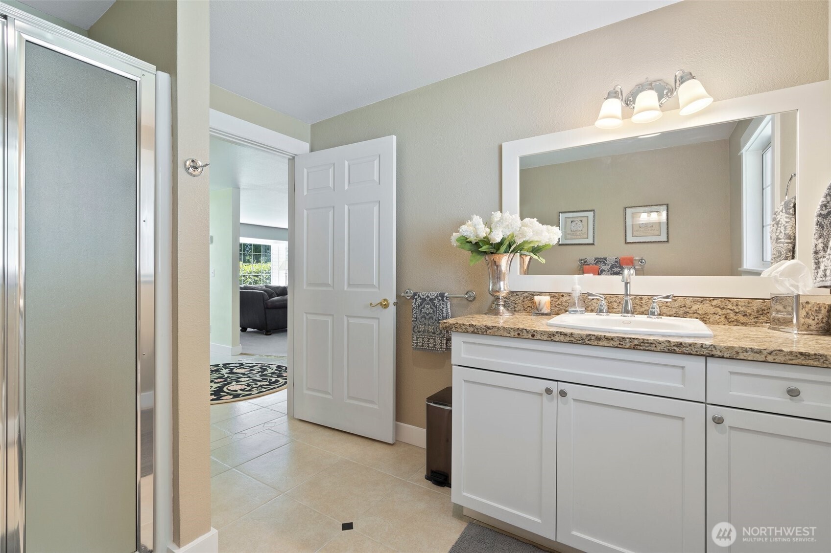 629 Brockway Road Chehalis, WA 98532 - Photo 13 of 40 a bathroom with a granite countertop sink a mirror and a shower