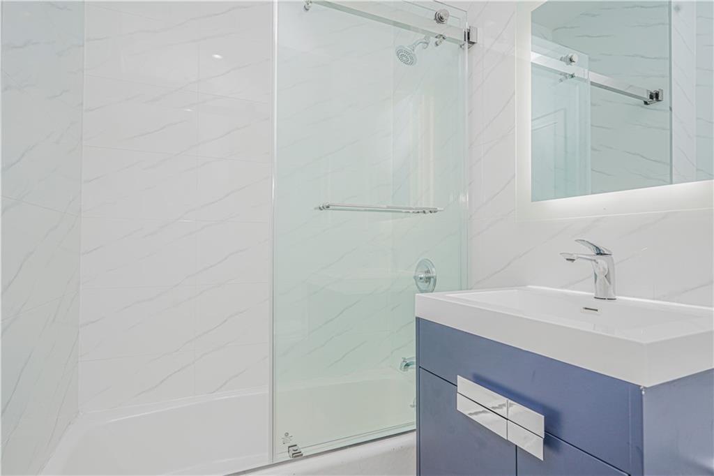 158 Bay 29th Street Brooklyn, NY 11214 - Photo 7 of 24 a bathroom with a sink and a mirror