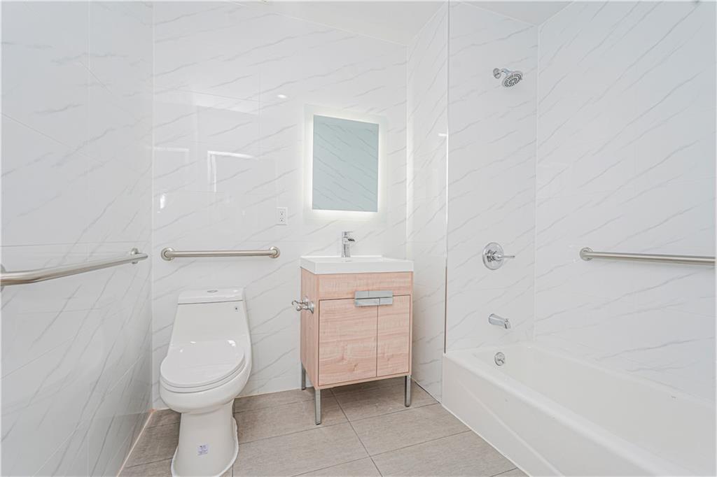 158 Bay 29th Street Brooklyn, NY 11214 - Photo 9 of 24 a bathroom with a toilet sink and bathtub