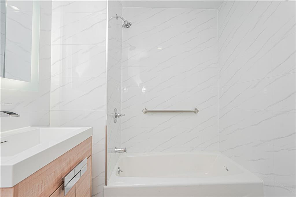 158 Bay 29th Street Brooklyn, NY 11214 - Photo 10 of 24 a bathroom with a bathtub and a sink