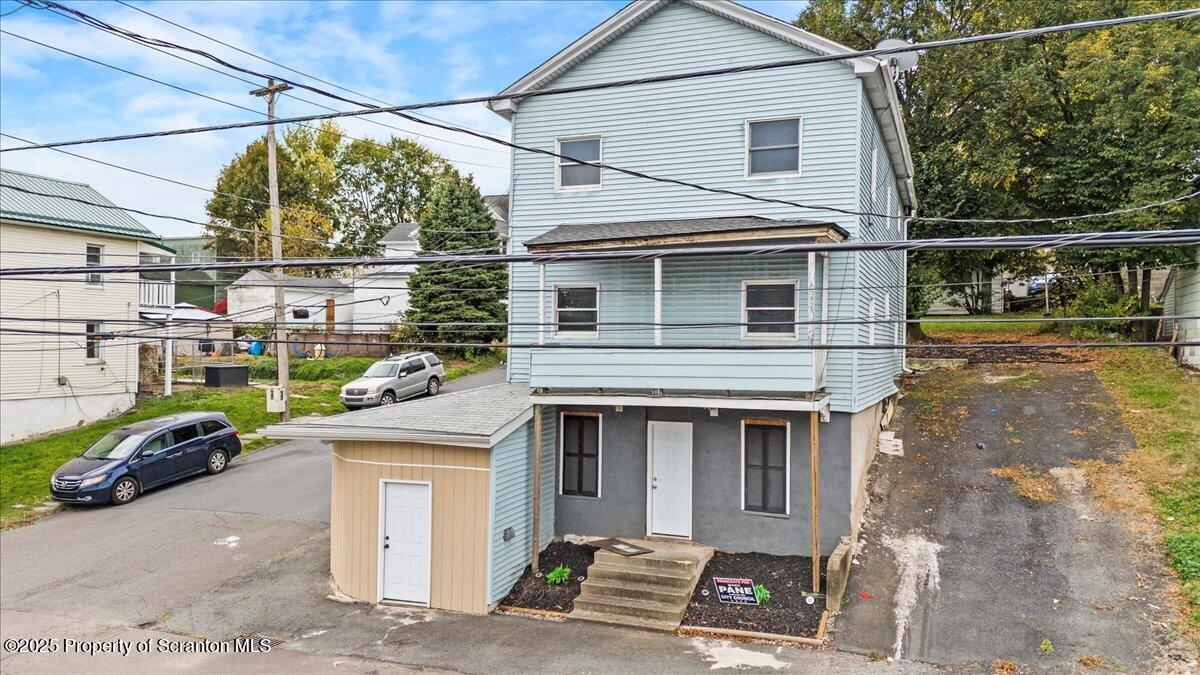901 Eynon Street Scranton, PA 18504 - Photo 1 of 34 a front view of a house with a garden and parking