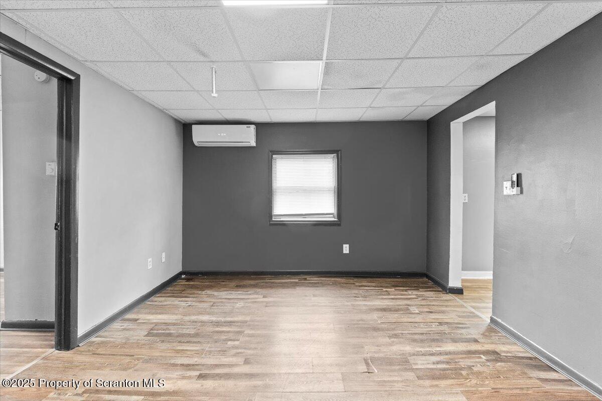 901 Eynon Street Scranton, PA 18504 - Photo 14 of 34 a view of an empty room with wooden floor and a window