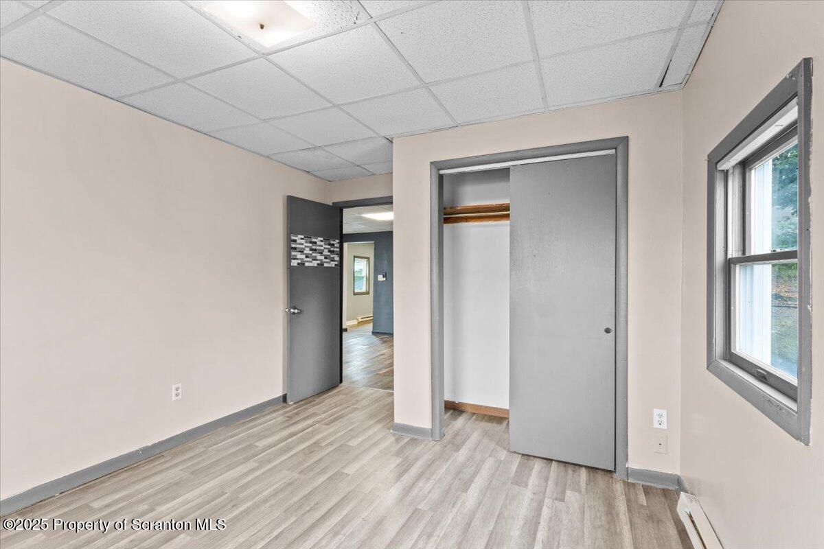 901 Eynon Street Scranton, PA 18504 - Photo 17 of 34 a view of an empty room with window and wooden floor