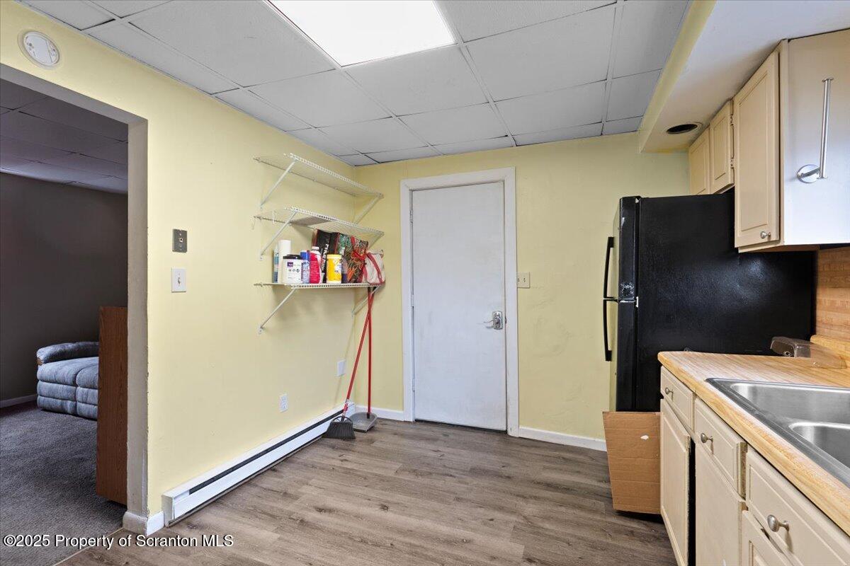 901 Eynon Street Scranton, PA 18504 - Photo 24 of 34 a view of a kitchen with fridge and wooden floor