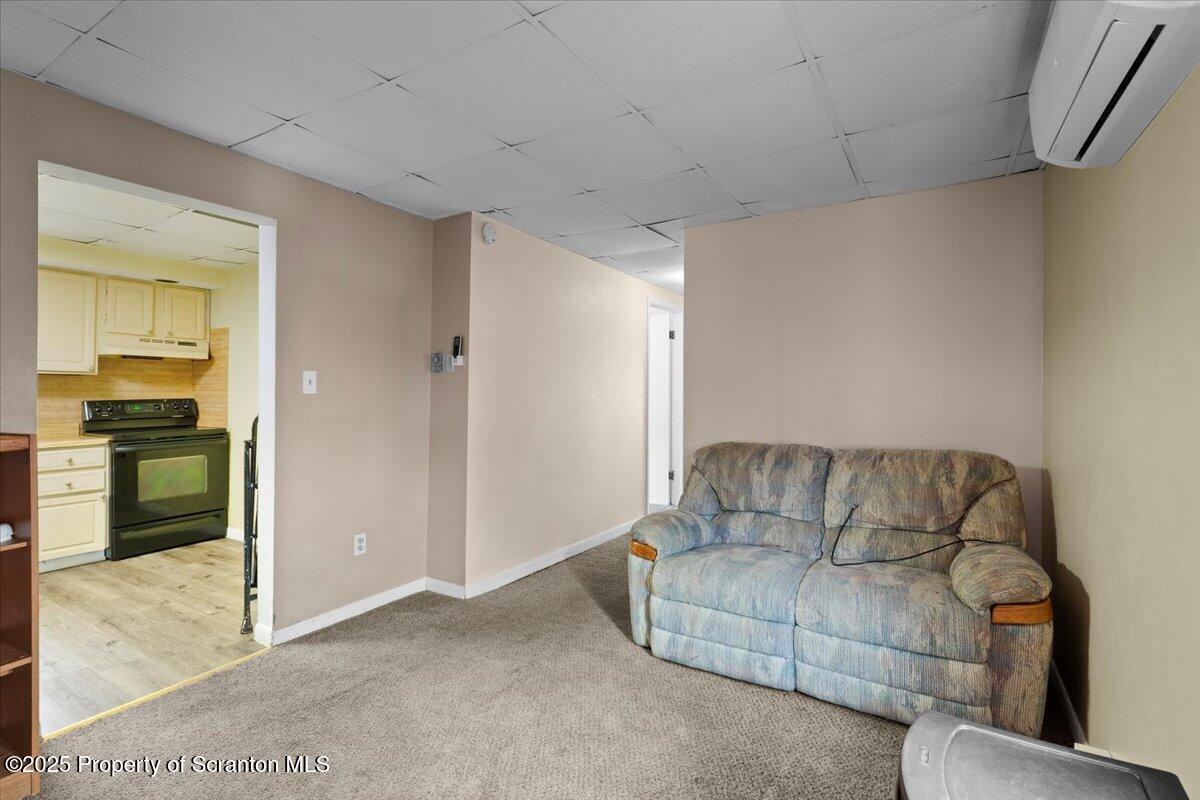 901 Eynon Street Scranton, PA 18504 - Photo 25 of 34 a living room with furniture and kitchen view