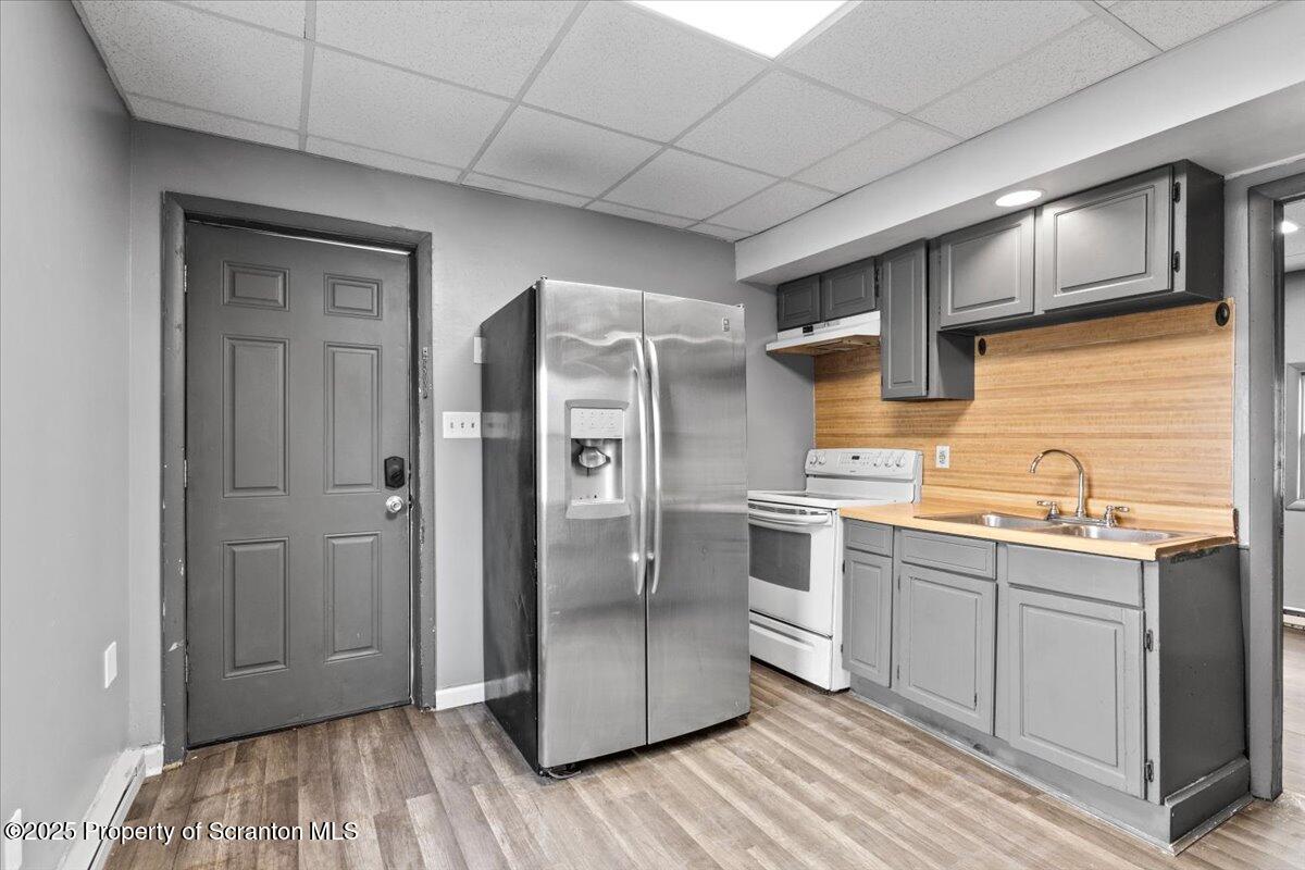 901 Eynon Street Scranton, PA 18504 - Photo 10 of 34 a kitchen with stainless steel appliances granite countertop a refrigerator a sink and wooden cabinets
