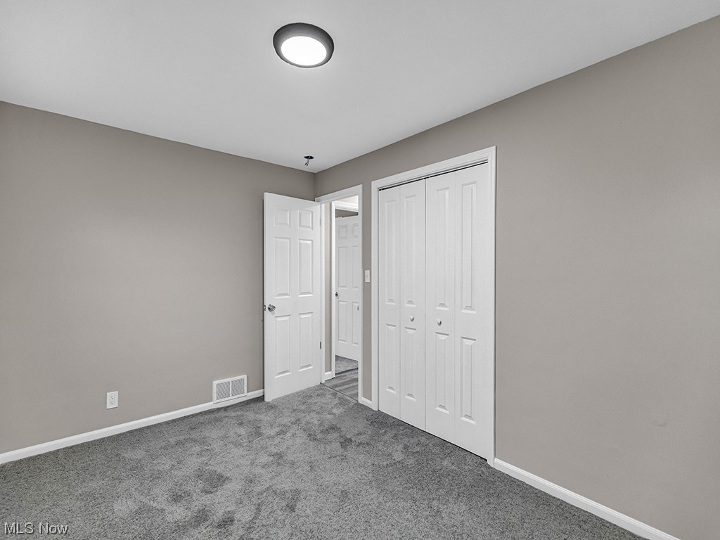 1661 Rush Road Wickliffe, OH 44092 - Photo 13 of 26 Unfurnished bedroom with a closet and carpet flooring