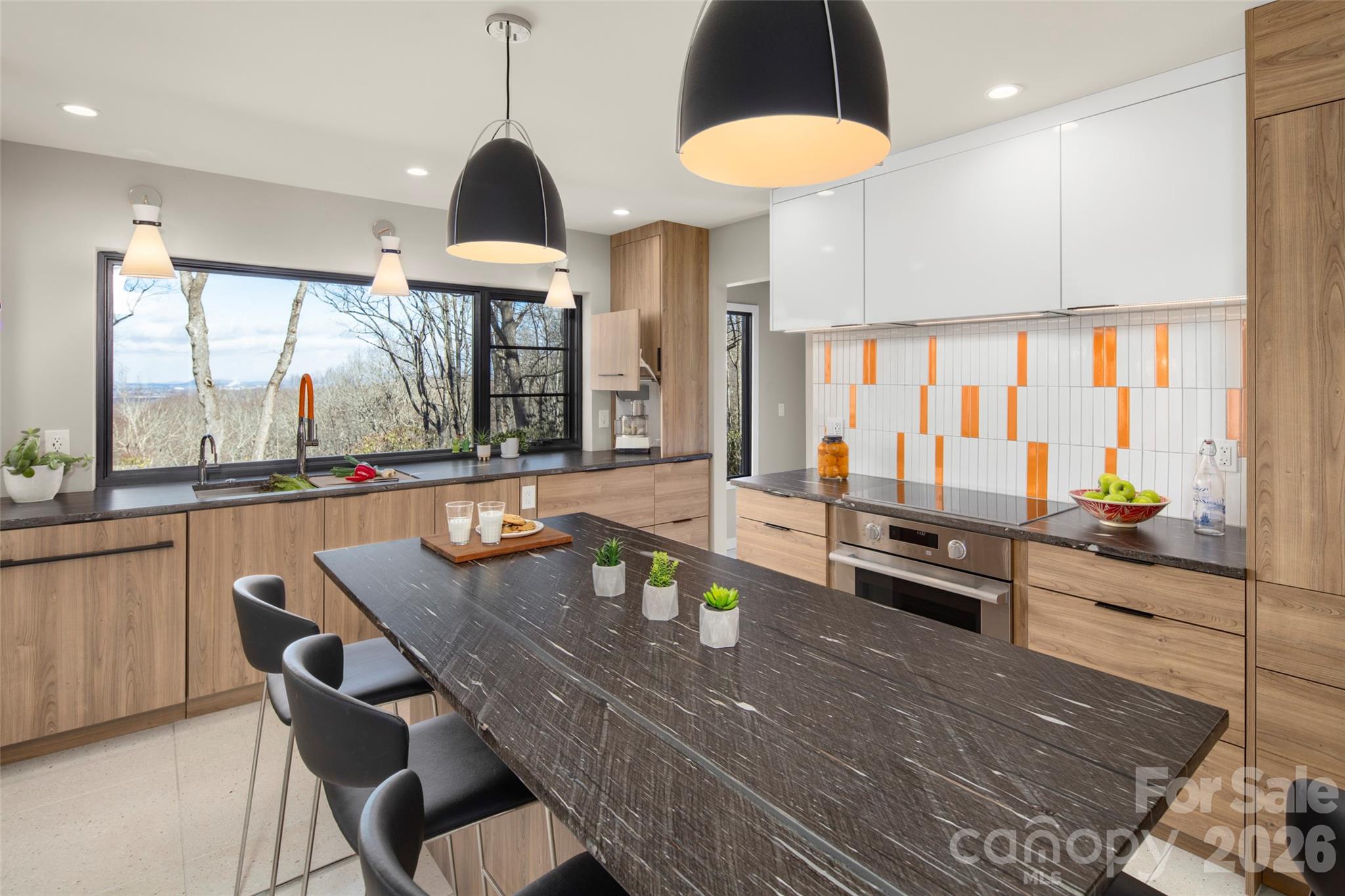 1202 Davis Mountain Road Hendersonville, NC 28739 - Photo 15 of 43 a dining room with furniture a chandelier and wooden floor