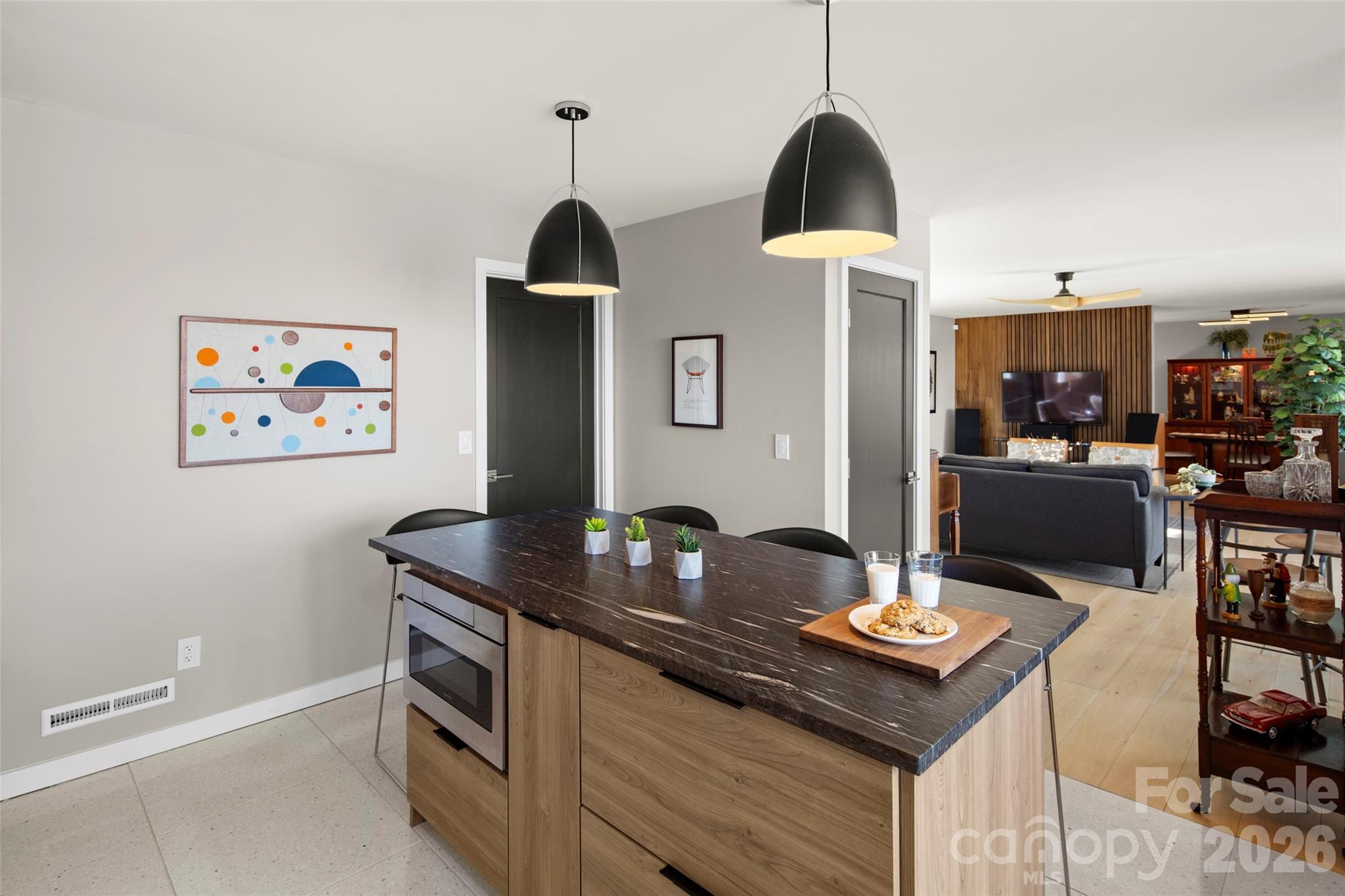 1202 Davis Mountain Road Hendersonville, NC 28739 - Photo 18 of 43 a kitchen with stainless steel appliances granite countertop a stove a sink a dining table and chairs with wooden floor