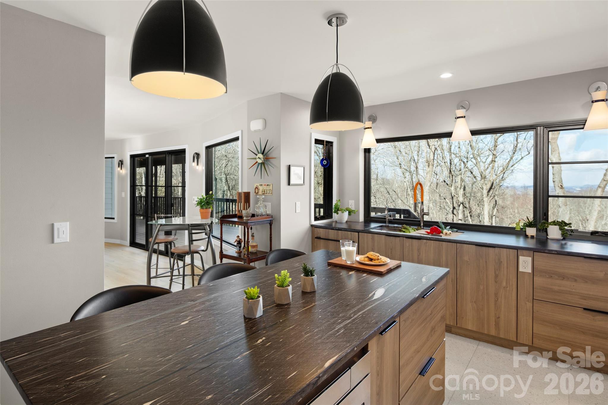 1202 Davis Mountain Road Hendersonville, NC 28739 - Photo 2 of 43 a kitchen with stainless steel appliances a dining table chairs and a wooden floor