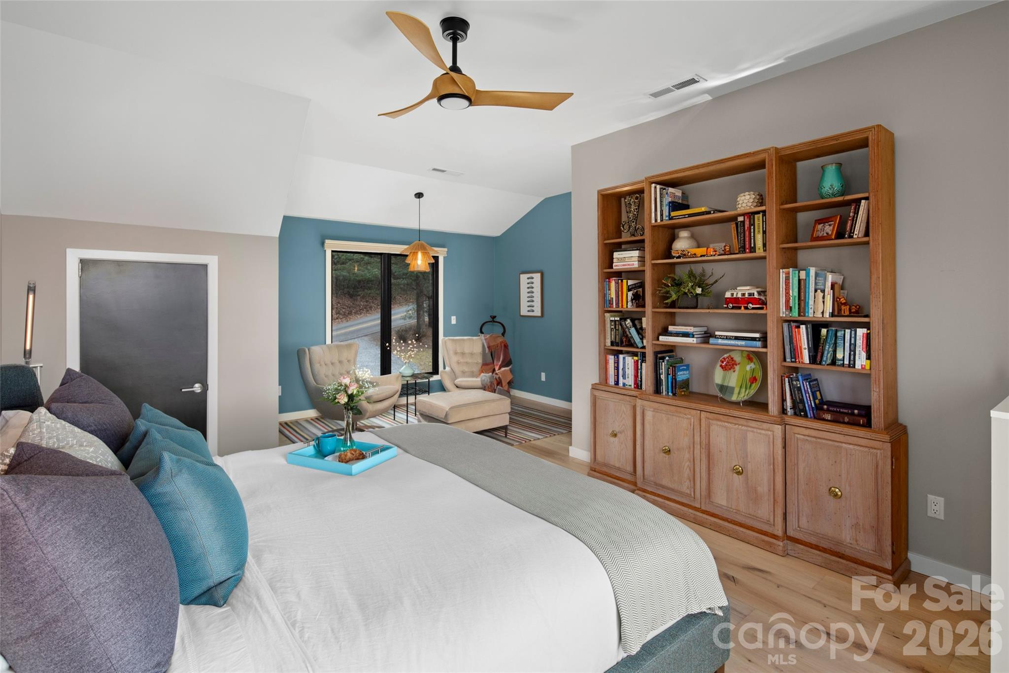 1202 Davis Mountain Road Hendersonville, NC 28739 - Photo 21 of 43 a bedroom with bed and a book shelf