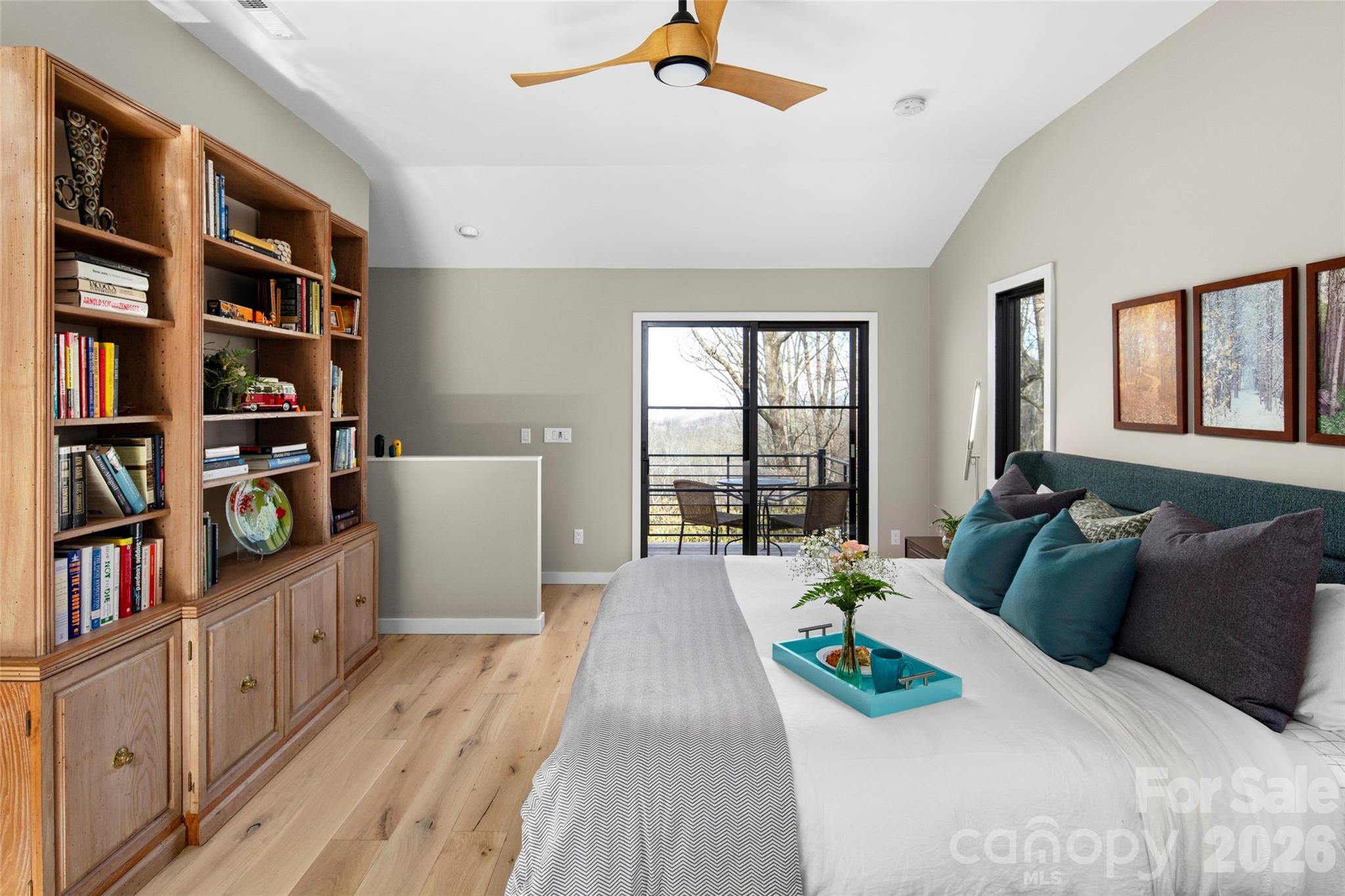 1202 Davis Mountain Road Hendersonville, NC 28739 - Photo 22 of 43 a bed sitting in a bedroom next to a book shelf