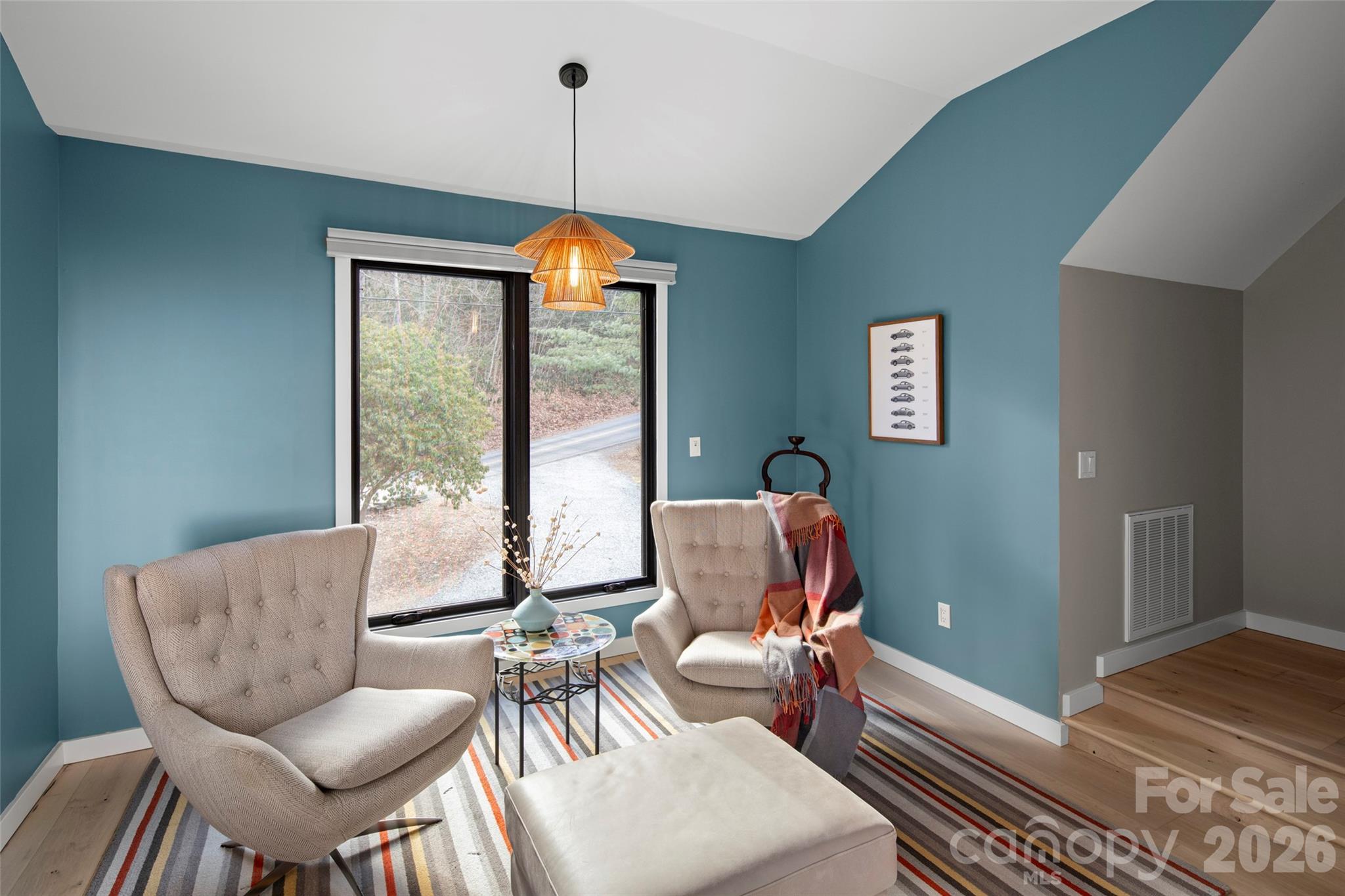 1202 Davis Mountain Road Hendersonville, NC 28739 - Photo 23 of 43 a living room with furniture a couch and a chandelier