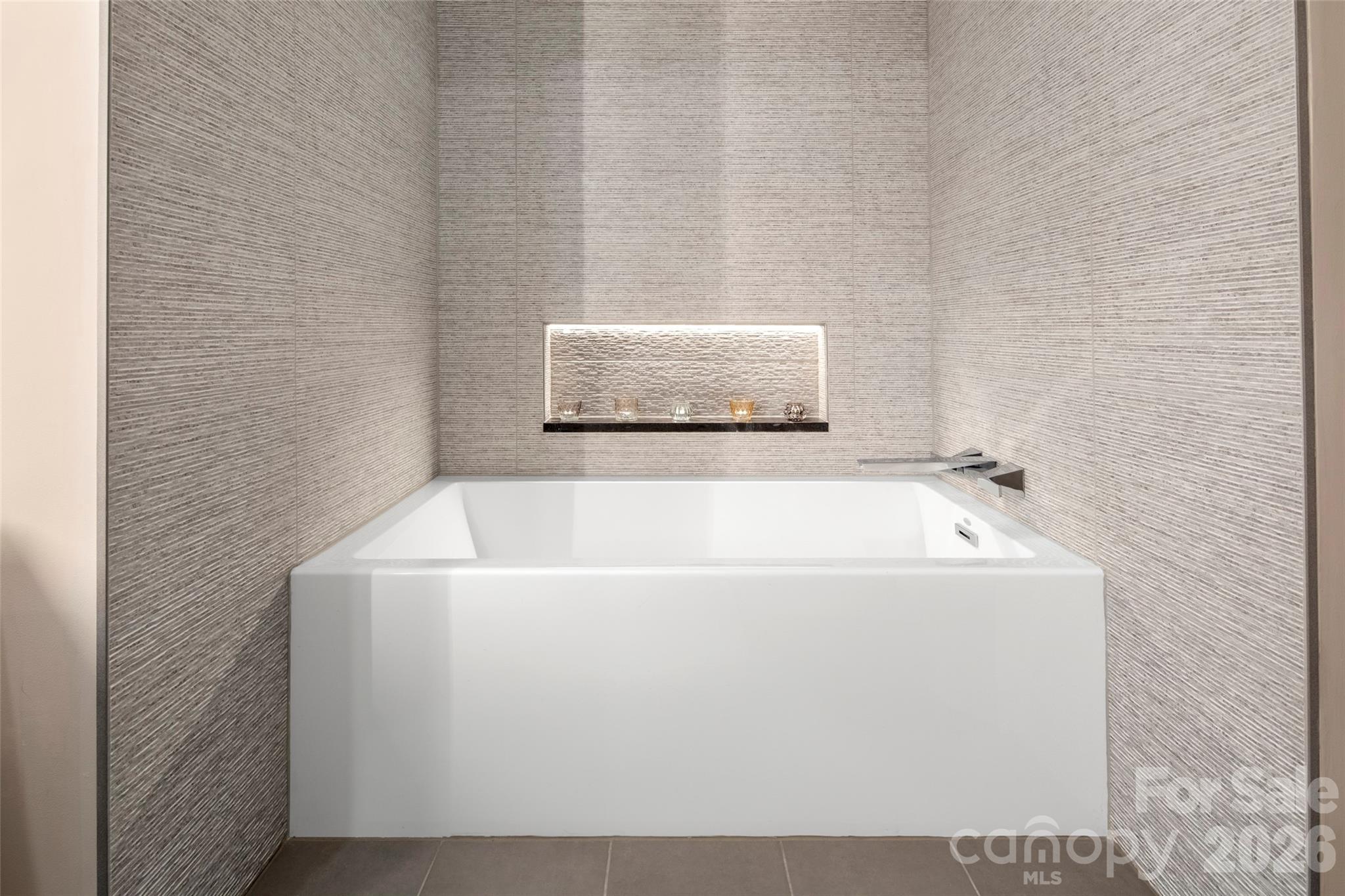 1202 Davis Mountain Road Hendersonville, NC 28739 - Photo 25 of 43 a white bath tub sitting in a bathroom