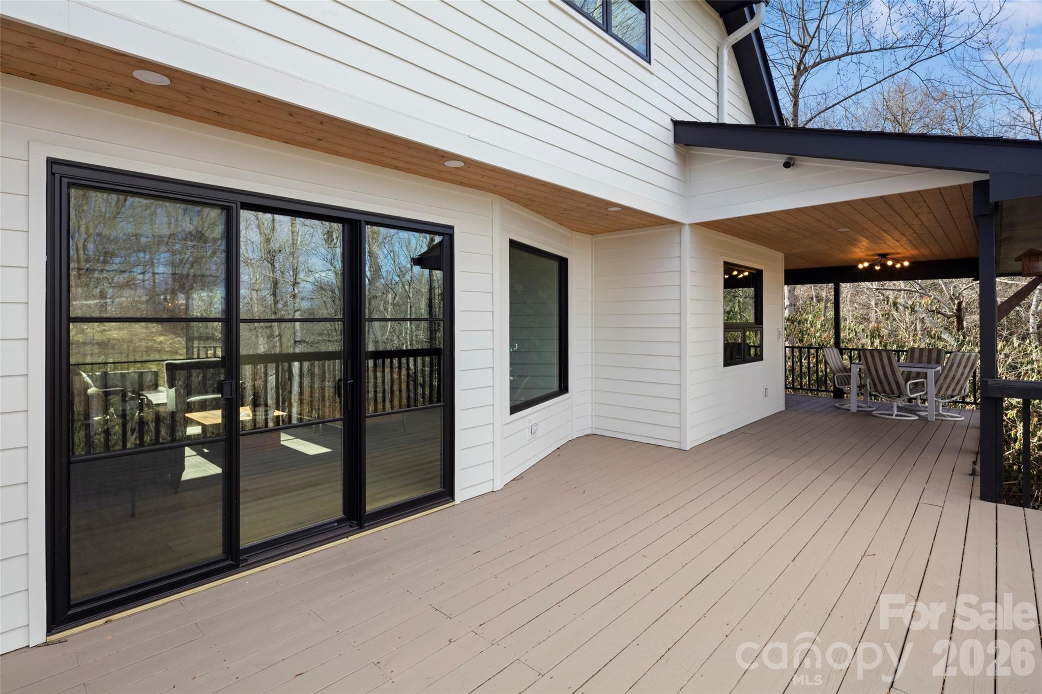 1202 Davis Mountain Road Hendersonville, NC 28739 - Photo 31 of 43 a view of a porch with wooden floor and floor to ceiling window