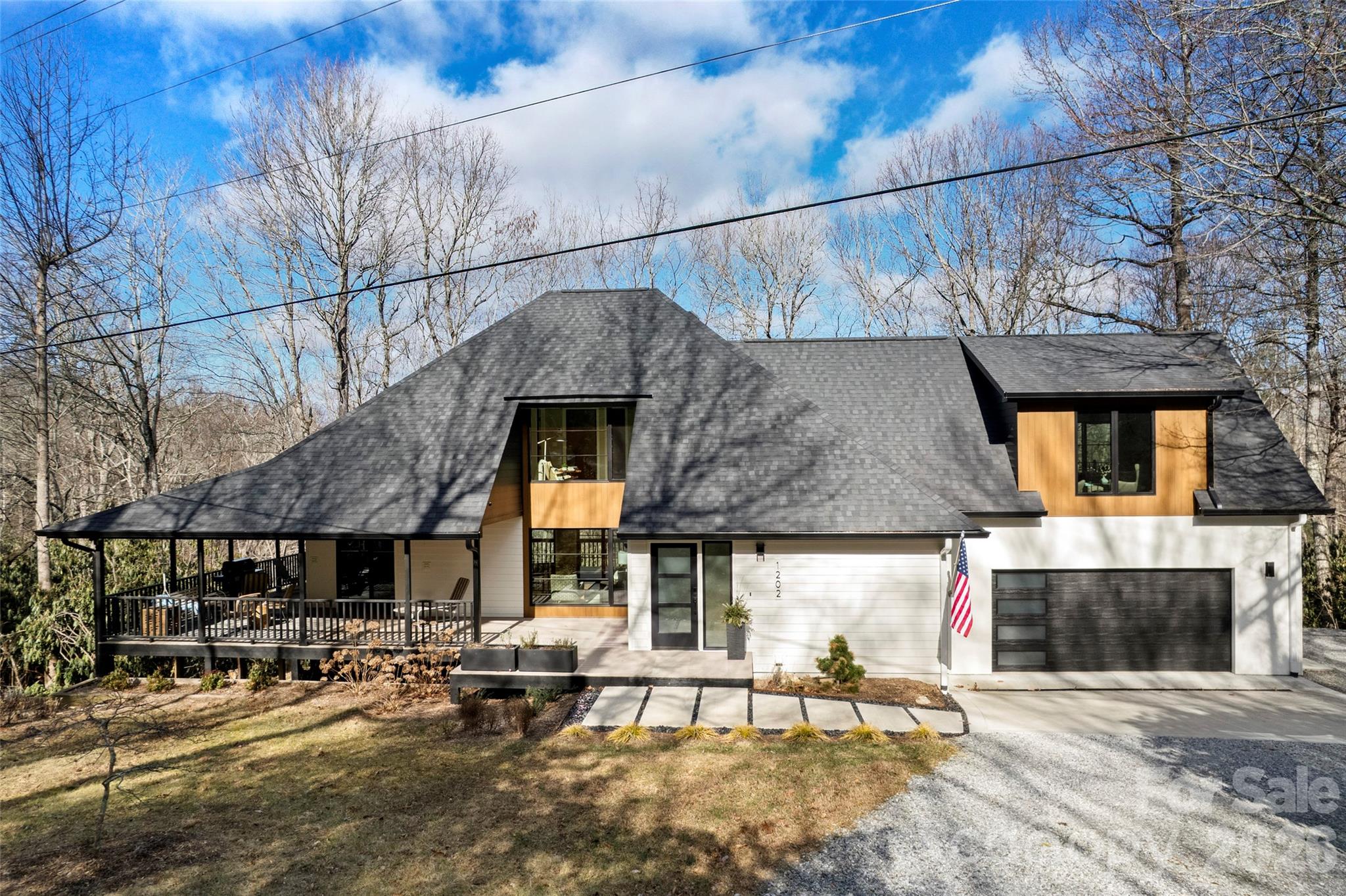 1202 Davis Mountain Road Hendersonville, NC 28739 - Photo 42 of 43 a view of a patio with table and chairs with wooden floor and fence