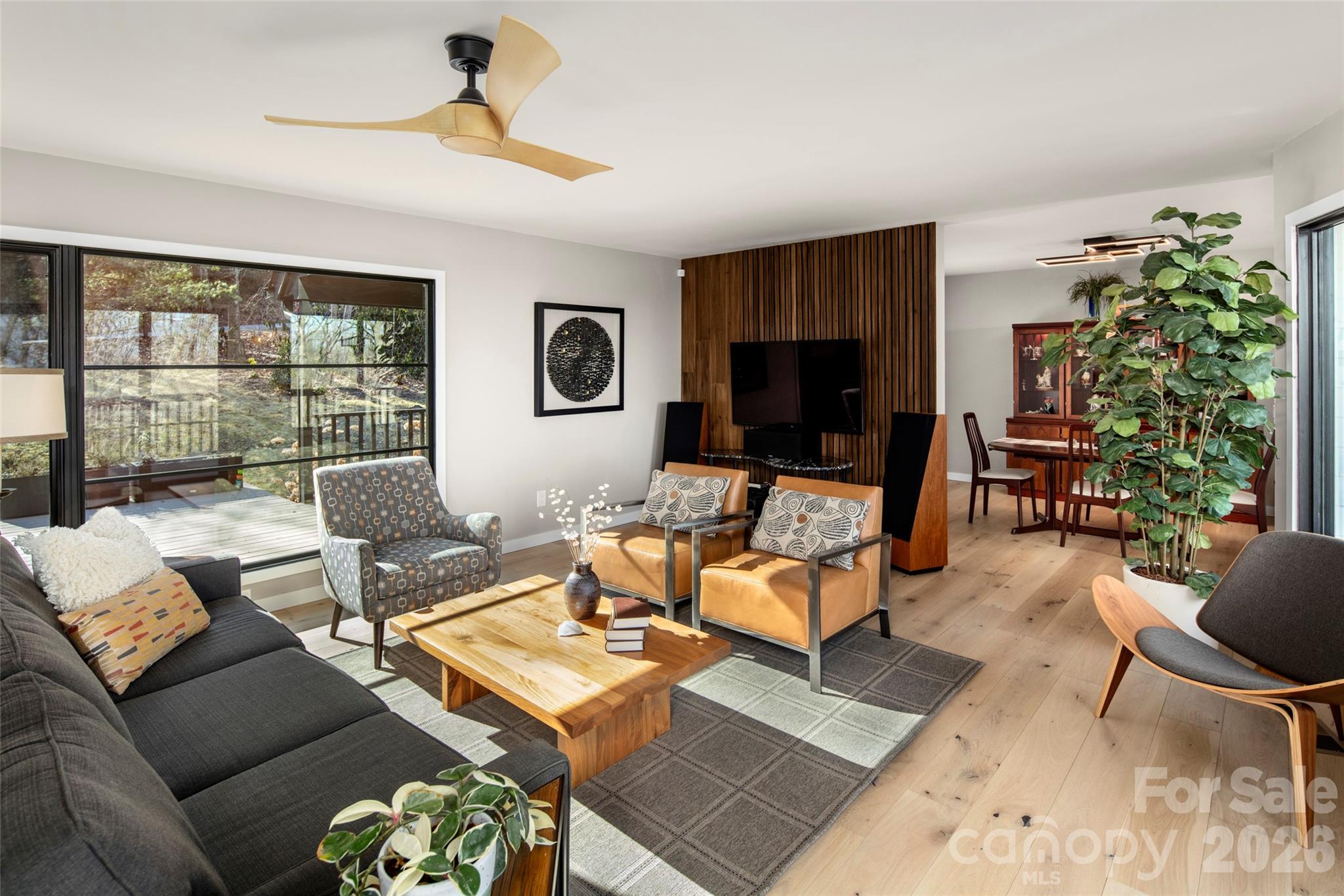 1202 Davis Mountain Road Hendersonville, NC 28739 - Photo 7 of 43 a living room with furniture a flat screen tv and a large window
