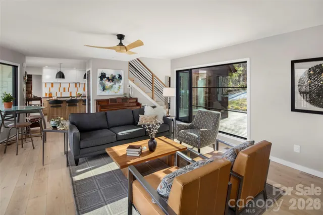 a living room with furniture and wooden floor