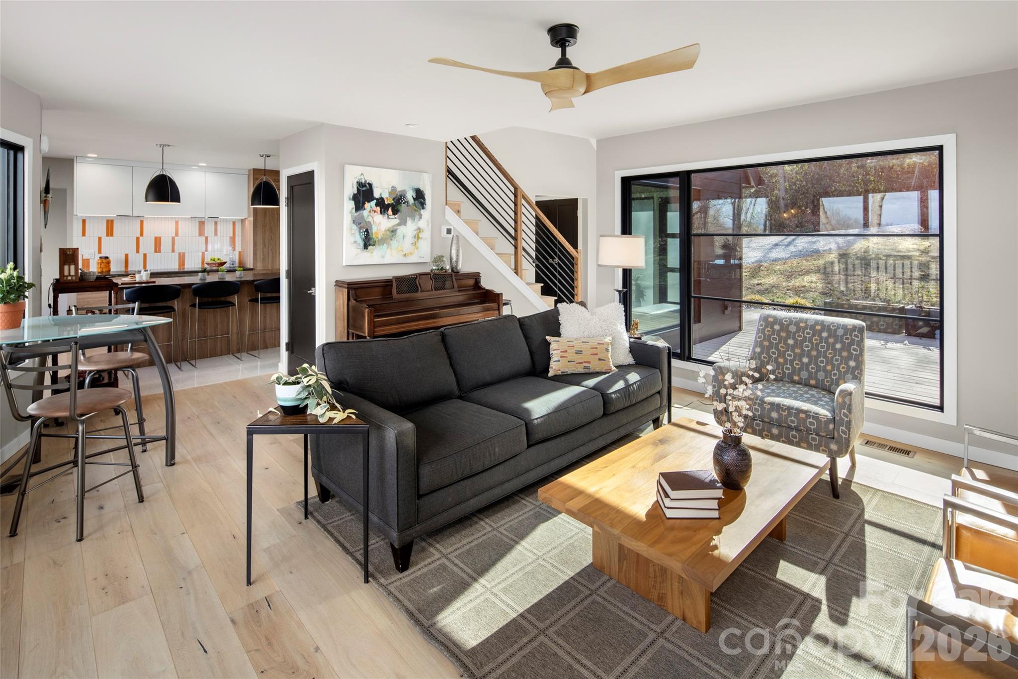 1202 Davis Mountain Road Hendersonville, NC 28739 - Photo 10 of 43 a living room with furniture a ceiling fan and a window