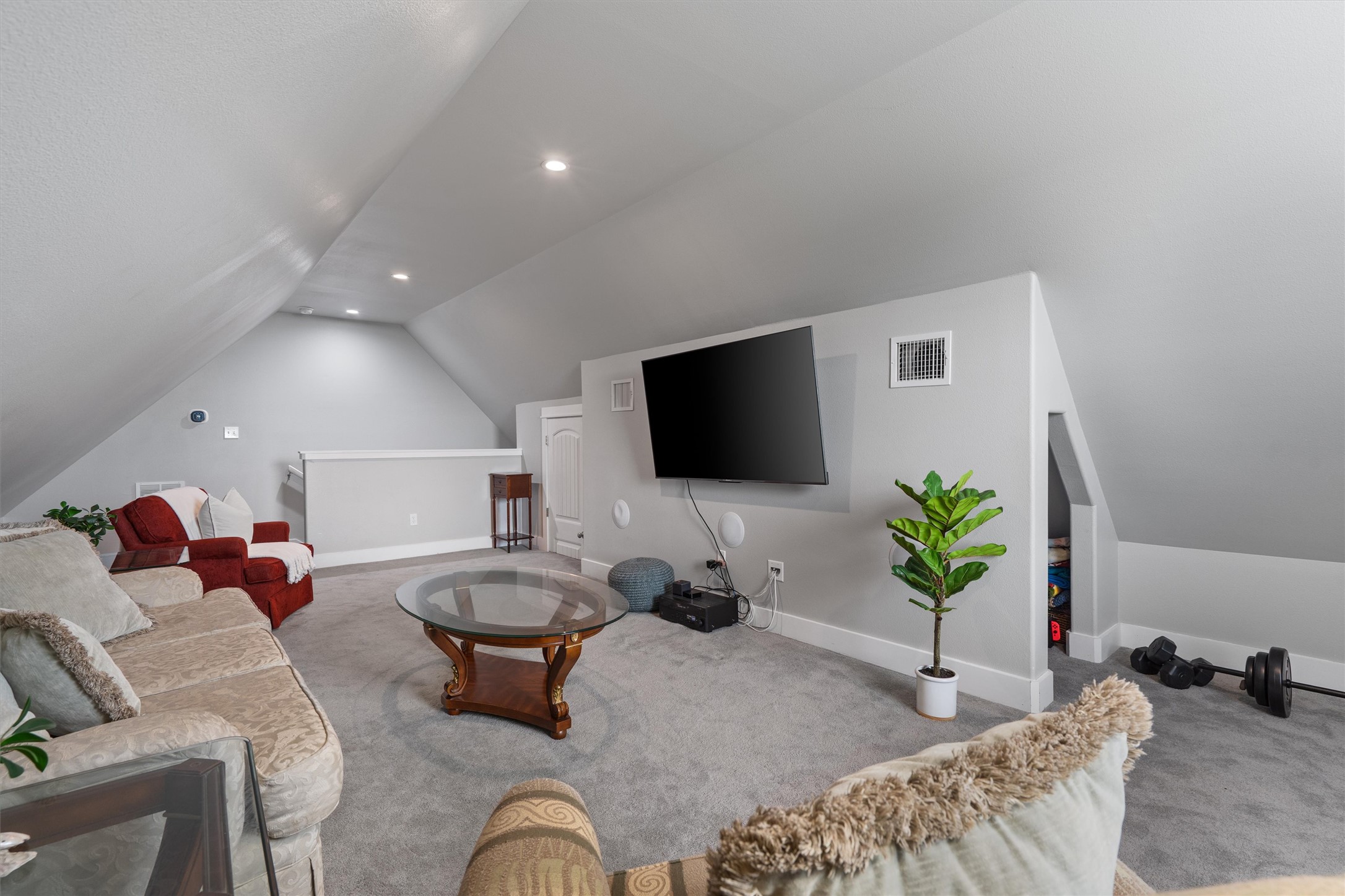 13105 Rooster Springs Road Austin, TX 78737 - Photo 21 of 38 This spacious loft area features vaulted ceilings, recessed lighting, and soft carpet flooring