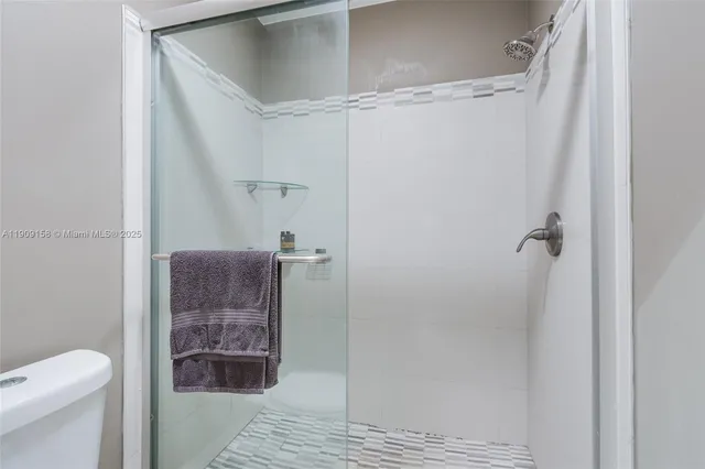 a view of a room with gym equipment and a large window