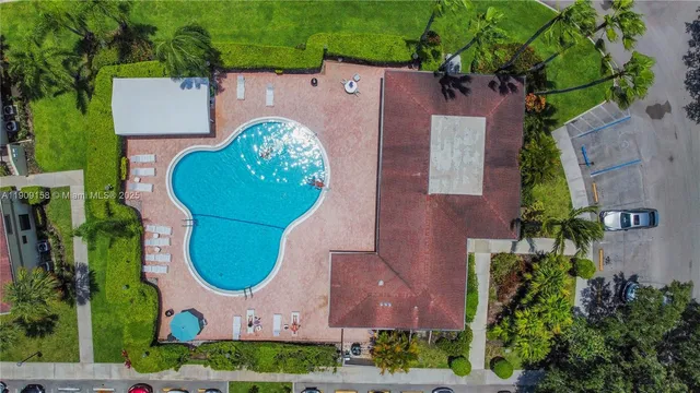 a view of a yard with swimming pool and sitting area