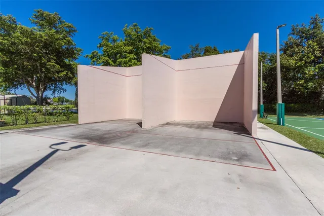 a view of a swimming pool with a patio and fire pit