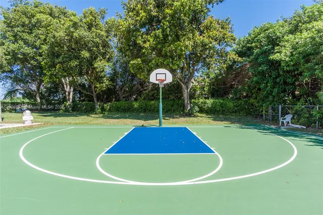 a front view of a house with a yard and potted plants