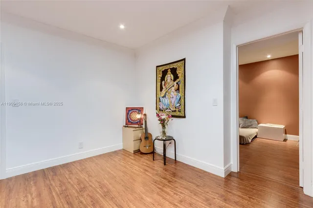 a bedroom with a bed and a ceiling fan