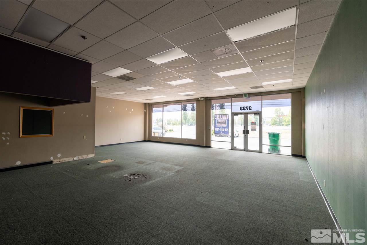 3733 North Carson Street, Unit 3733 Carson City, NV 89706 - Photo 4 of 8 a view of an empty room with a fireplace and a window