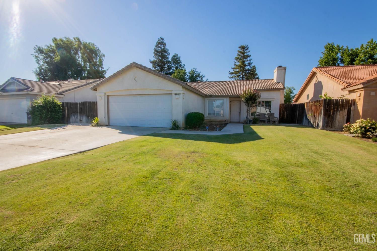 a view of a house with pool and a yard