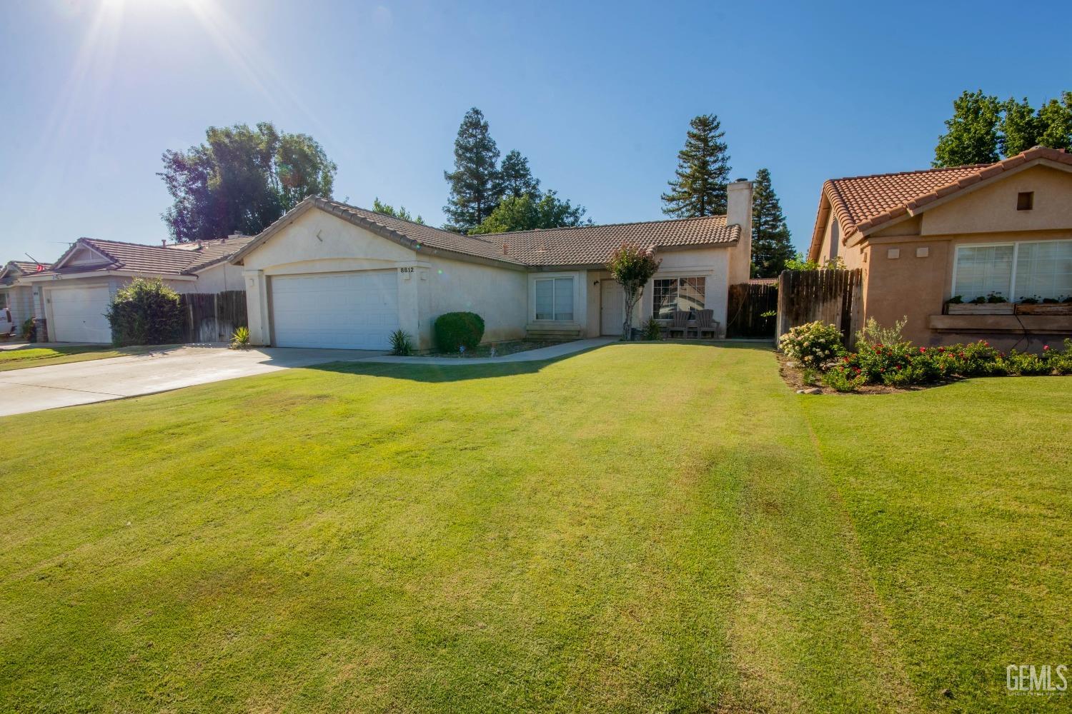 Undisclosed Address Bakersfield, CA 93312 - Photo 2 of 9 a view of a house with yard and garage