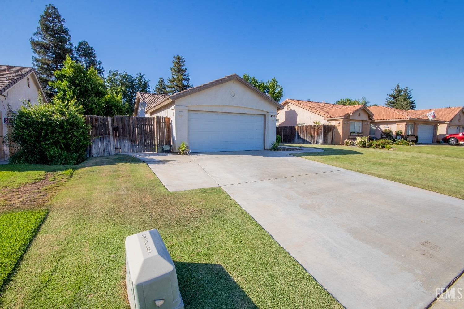 Undisclosed Address Bakersfield, CA 93312 - Photo 3 of 9 a front view of house with yard and trees in the background