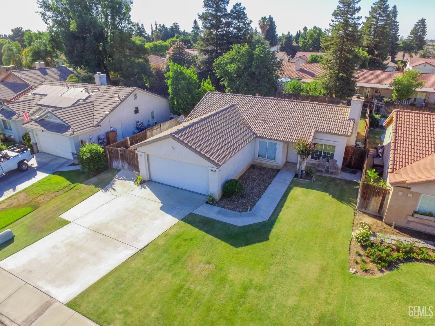 Undisclosed Address Bakersfield, CA 93312 - Photo 5 of 9 an aerial view of a house with swimming pool and large trees