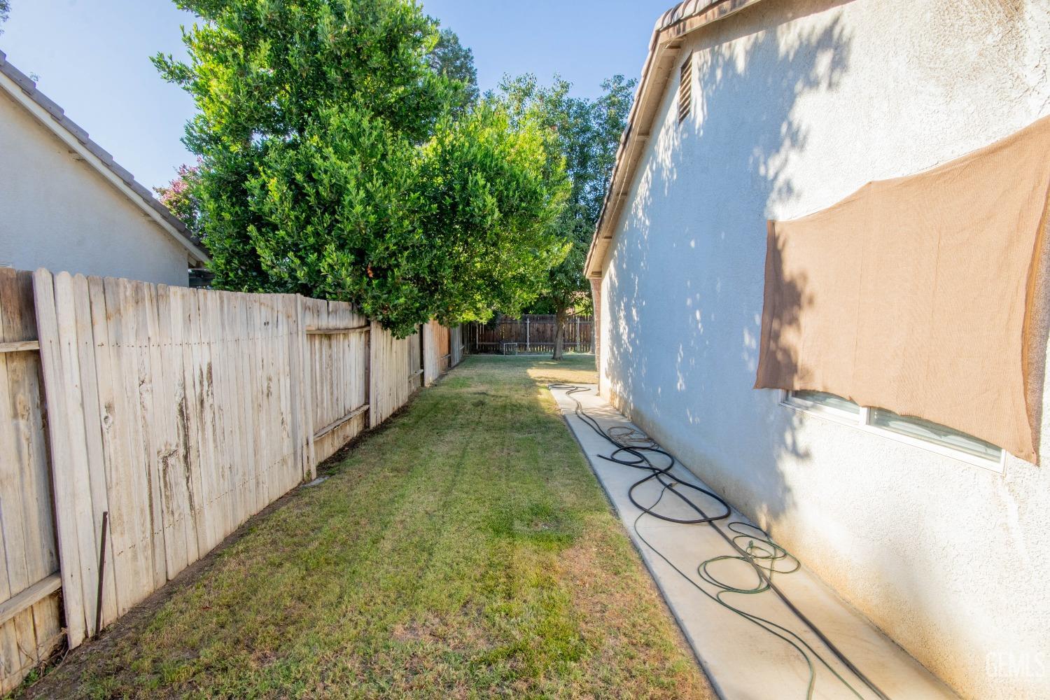 Undisclosed Address Bakersfield, CA 93312 - Photo 7 of 9 a view of a yard with potted plants
