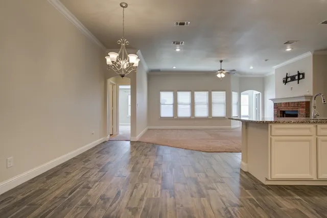 a view of a kitchen with wooden floor and a window
